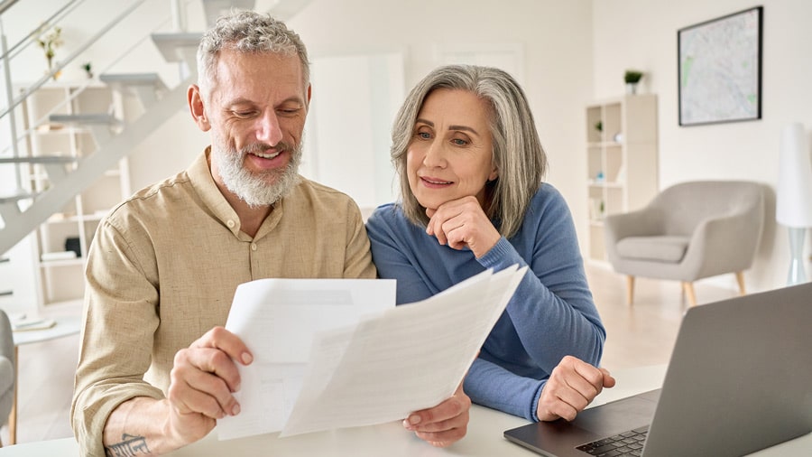 A couple looks over their retirement options. There are important differences between 403b, 457b, and 401k retirement plans.